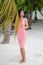 Young beautiful girl is photographed with a large sheet of palm trees