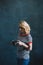 Young beautiful girl photographer with a camera in her hands in a photo studio. Women`s work is a hobby. Soft selective focus