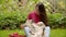 Young, beautiful girl playing with dog in garden