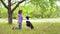 Young beautiful girl playing with her dog in the Park.