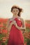 Young beautiful girl in poppy field