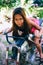 Young beautiful girl posing on the old rusty motorbike