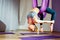 Young beautiful girl practicing aerial yoga in gym