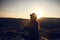 Young beautiful girl practicing yoga at the top of a mountain in Cappadocia at sunrise. Practices of relaxation.