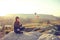 Young beautiful girl practicing yoga at the top of a mountain in Cappadocia at sunrise. Practices of relaxation.