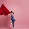 Young and beautiful girl with a red flag on a pink background. A socially active woman, to protest and fight for rights