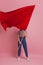 Young and beautiful girl with a red flag on a pink background. A socially active woman, to protest and fight for rights