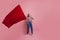 Young and beautiful girl with a red flag on a pink background. A socially active woman, to protest and fight for rights