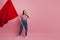 Young and beautiful girl with a red flag on a pink background. A socially active woman, to protest and fight for rights