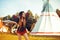 Young beautiful girl smiling on background teepee, tipi- native indian house. Pretty girl in hat with long cerly hair