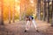 Young beautiful girl sports in the autumn forest at sunset