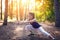 Young beautiful girl sports in the autumn forest at sunset