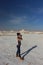Young beautiful girl takes a picture in the middle of the amazing White desert close to Farafra oasis in Egypt