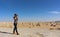 Young beautiful girl takes a picture in the middle of the amazing White desert close to Farafra oasis in Egypt