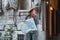 Young beautiful girl tourist is looking on the map of the city where to go. In the background is a beautiful old building and an