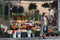 Young beautiful girl tourist looks away on the background of the store with bright bouquets and flowers