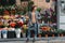 Young beautiful girl tourist looks away. Full-length photo. In the background are beautiful bright bouquets with flowers