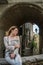 Young beautiful girl during a walk through the antique streets of the old Italian city