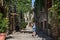 Young beautiful girl during a walk through the antique streets of the old Italian city