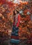 Young beautiful girl walking in autumn forest