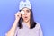 Young beautiful girl wearing funny sleep mask using makeup remover cotton scared and amazed with open mouth for surprise,