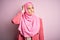 Young beautiful girl wearing muslim hijab standing over  pink background confuse and wondering about question