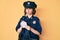 Young beautiful girl wearing police uniform writing traffic fine clueless and confused expression