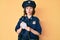 Young beautiful girl wearing police uniform writing traffic fine making fish face with mouth and squinting eyes, crazy and comical