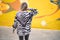 Young beautiful girl wearing sunglasses standing on backview at the town street