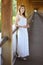 Young beautiful girl in a white dress close-up on the aqueduct bridge background