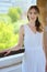 Young beautiful girl in a white dress close-up on the aqueduct bridge background