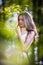 Young beautiful girl in a yellow dress in the woods. Portrait of romantic woman in fairy forest. Stunning fashionable teenager