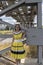 Young beautiful girl in yellow smart dress on a background of metal structures in the industrial zone, heating