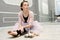 young beautiful graceful ballerina resting in ballet class sitting on the floor