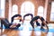 Young beautiful group of sportswomen practicing yoga
