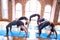 Young beautiful group of sportswomen practicing yoga