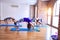 Young beautiful group of sportswomen  practicing yoga doing wheel pose at gym
