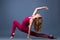Young beautiful gymnast woman in a jumpsuit shows gymnastic poses and exercises. Sport is a flexible, healthy body. Fit sporty
