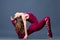Young beautiful gymnast woman in a jumpsuit shows gymnastic poses and exercises. Sport is a flexible, healthy body. Fit sporty
