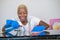 Young beautiful and happy African American black woman in washing rubber clothes cleaning home kitchen with cloth smiling cheerful