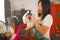 Young beautiful and happy Asian Chinese woman in apron and rubber glove washing dishes and bowl smiling cheerful in relaxed