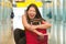 Young beautiful and happy Asian girl traveling excited - Chinese tourist woman smiling cheerful with trolley suitcase at airport