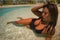 Young beautiful and happy Asian Indonesian woman in bikini swimming in tropical island pool resort enjoying luxury and exotic