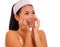 Young beautiful and happy Asian Korean woman applying skincare wrinkle prevention treatment or aging beauty product on her face in