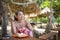 Young beautiful and happy Asian Korean woman in bikini having lunch brunch or breakfast at tropical paradise beach resort