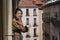 Young beautiful and happy Asian Korean woman enjoying city view from hotel room balcony in Spain during holidays trip in Europe