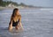 Young beautiful and happy Asian woman smiling relaxed having fun on tropical beach in Bali Asia