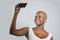 Young beautiful and happy black afro American woman smiling excited taking selfie picture portrait with mobile phone or recording