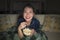 Young beautiful happy and cheerful Asian Korean woman watching TV comedy movie or hilarious show laughing and eating popcorn