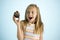 Young beautiful happy and excited blond girl 8 or 9 years old holding chocolate cake on her hand looking spastic and cheerful in s